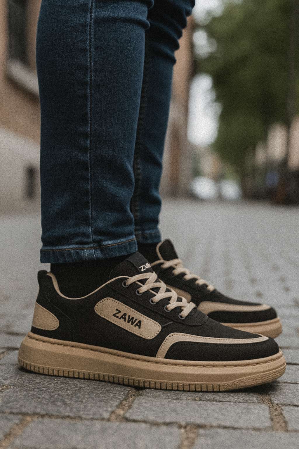 ZAWA black and tan sneakers for men styled with jeans on a city street.