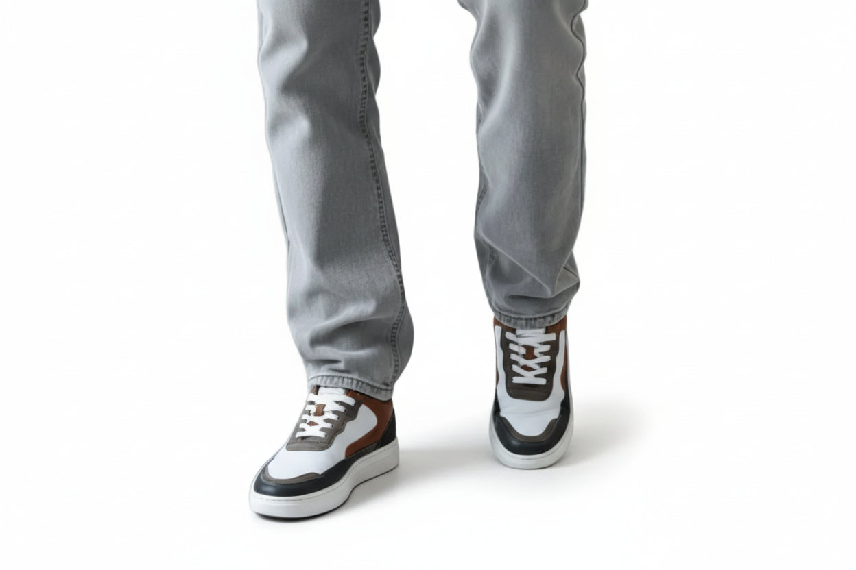 Pair of brown, white, and black zawa sneakers on a light gray background