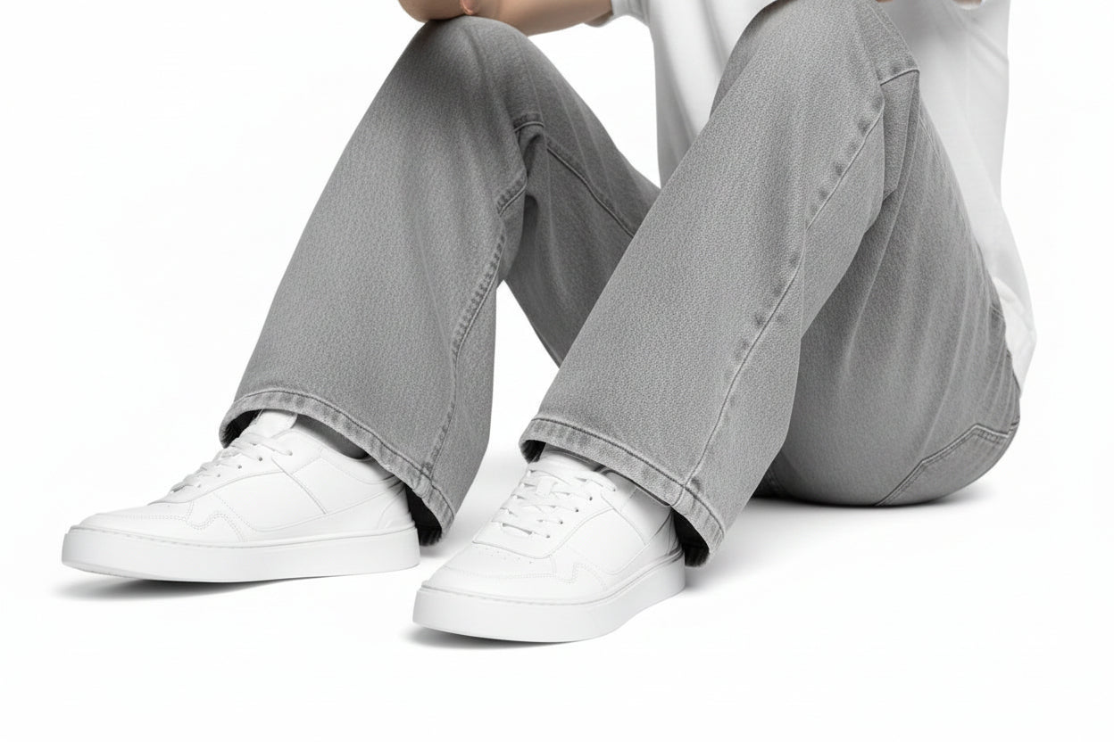 White zawa aurion sneakers worn with gray pants on a white background