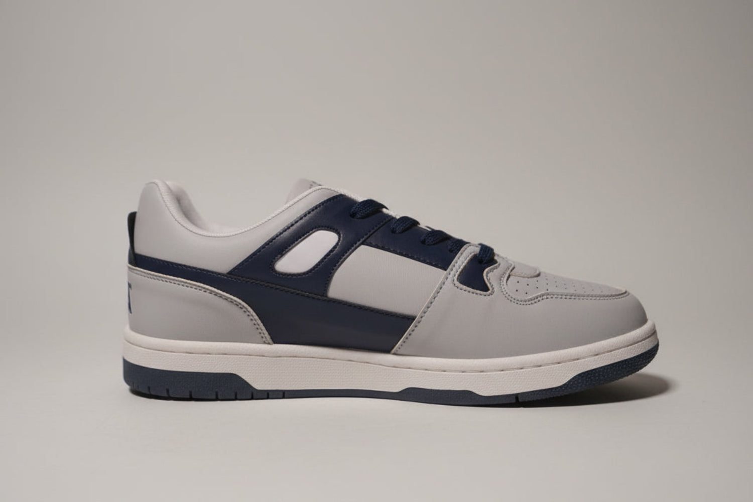 Gray and navy zawa coreflex sneaker on a plain background