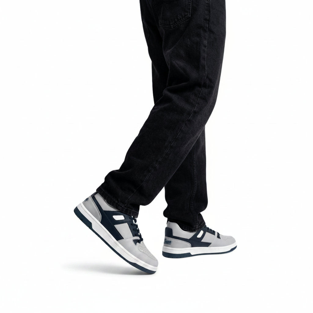 Person wearing black jeans and white zawa coreflex sneakers on a white background