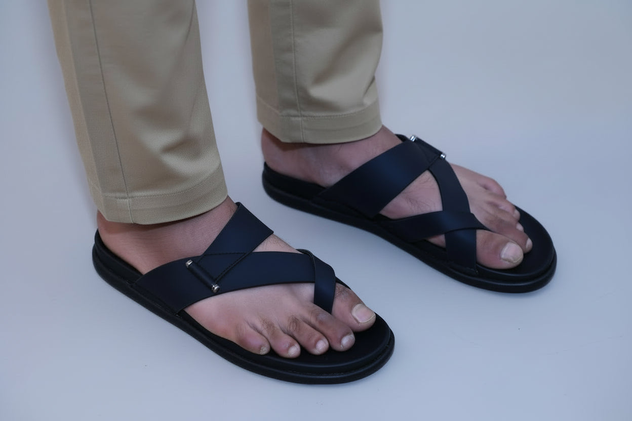 Person wearing zawa rivano black sandals on a plain background