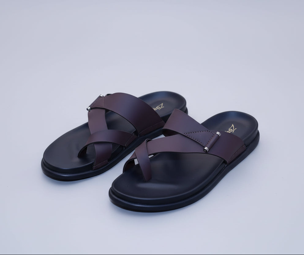 Pair of Zawa Cruze black sandals with brown straps on a plain background