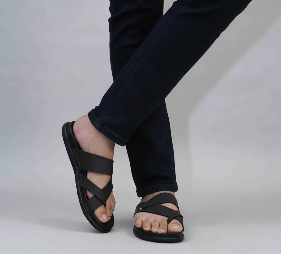 Person wearing Zawa Cruze black sandals and dark blue jeans 
