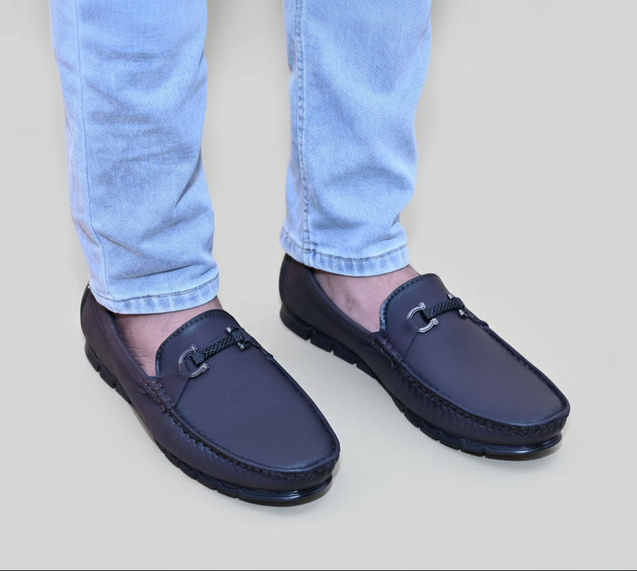 Zawa Monarcha loafers worn with light blue jeans on a wooden floor