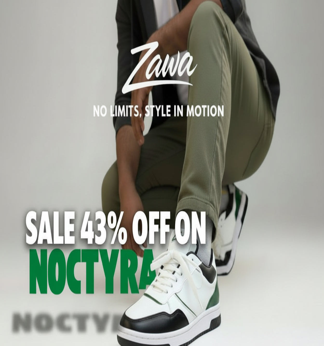 Person wearing white zawa noctyra sneakers with black and green accents, sitting on a light gray floor with 'Zawa' branding.