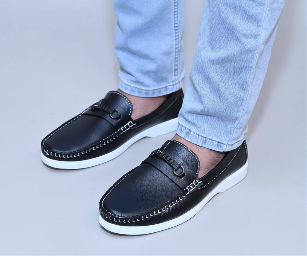 ZAWA Regent Black loafers worn with light blue jeans on a plain background
