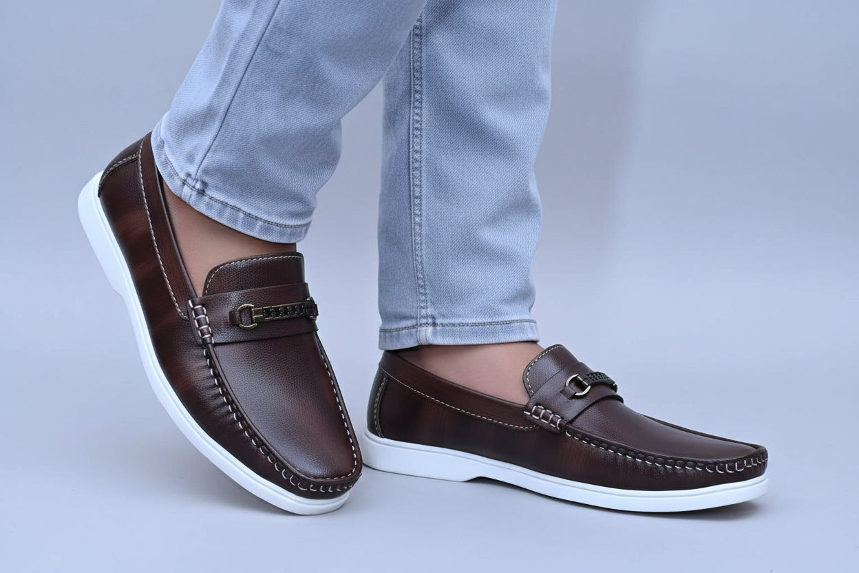 ZAWA Regent Brown leather loafer shoes with white soles worn with light blue jeans on a plain background.