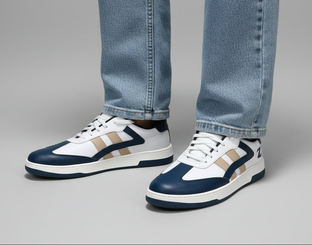 Pair of navy and white sneakers with zawa  brand logo on a gray background