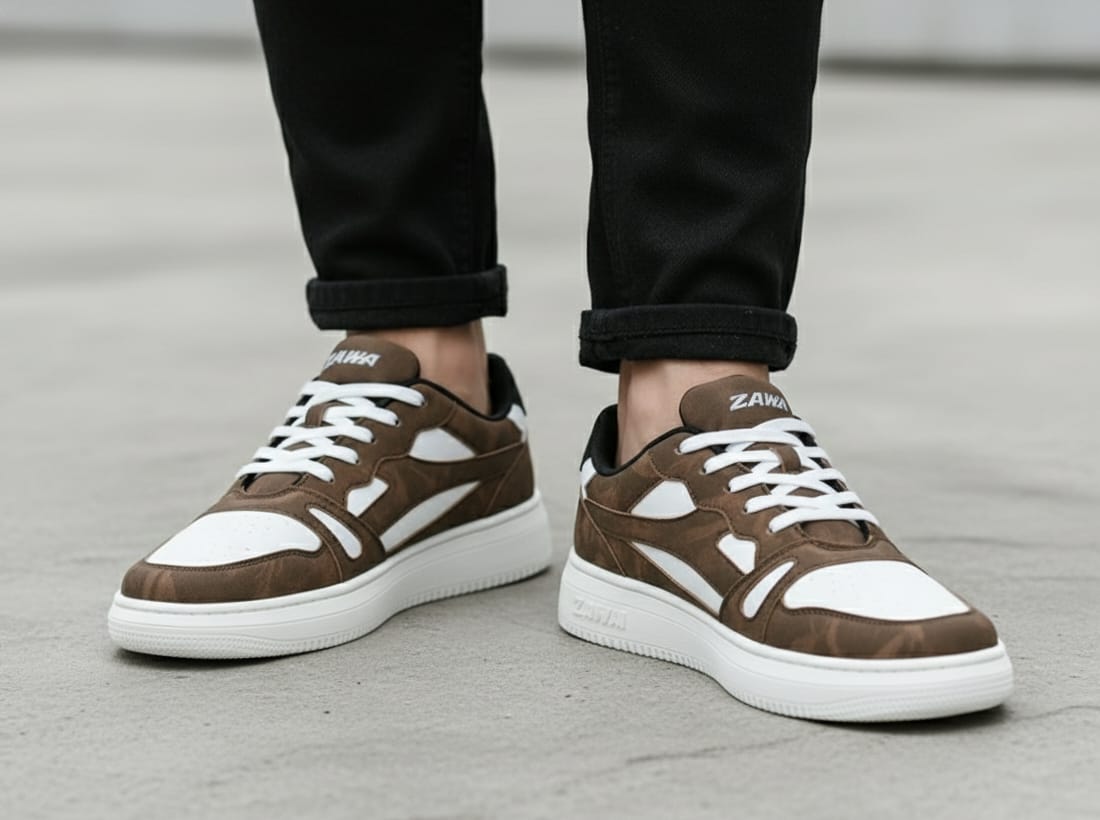 Brown zawa driftwood white sneakers with white soles worn by a person on a gray pavement.