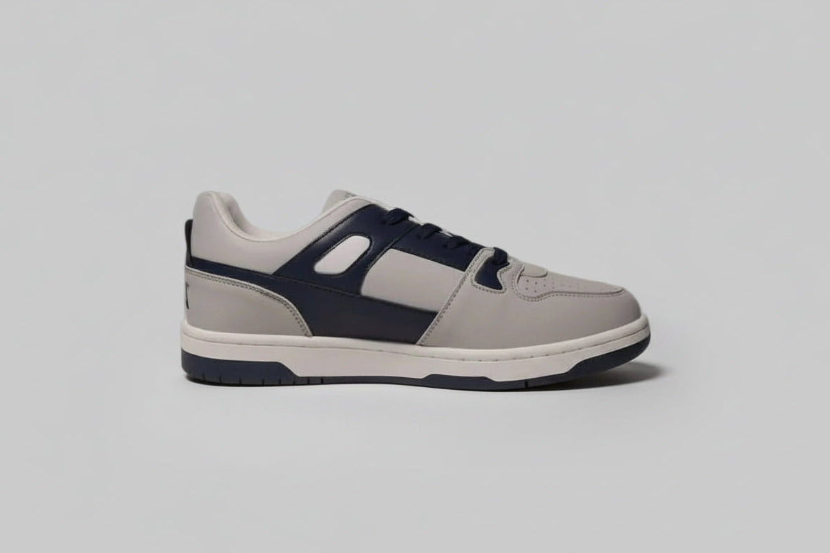 Gray and navy zawa noctyra sneaker on a light gray background