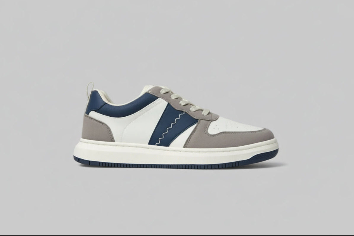 zawa shadow duneSneaker with gray, white, and blue design on a light gray background