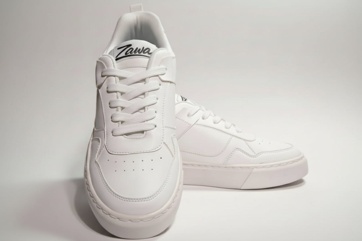 White sneakers with 'Zawa' branding on a light gray background
