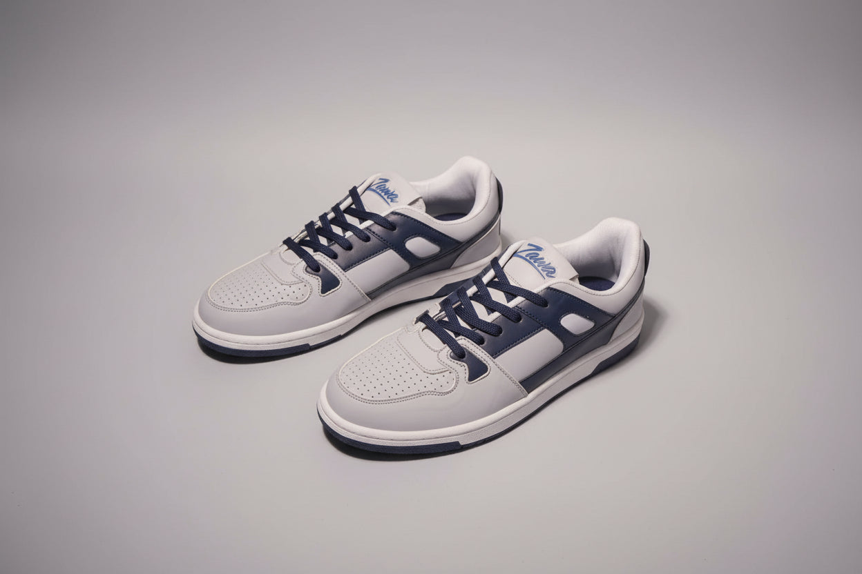 Pair of gray and blue Zawa coreflex  sneakers on a grey surface
