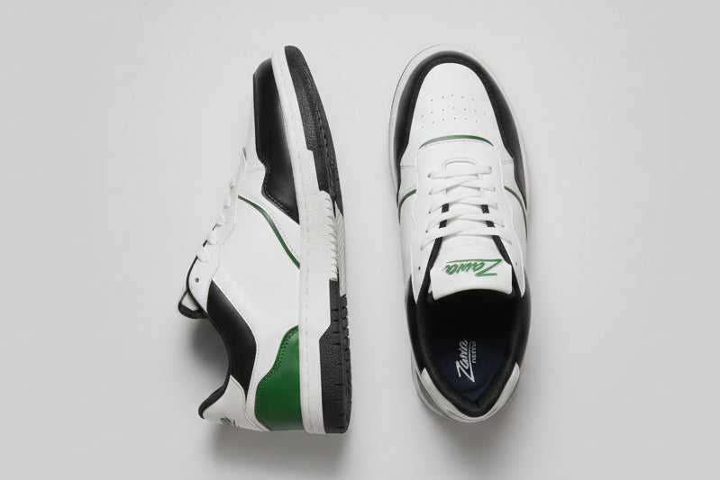 White zawa noctyra sneakers with black and green accents on a light grey background