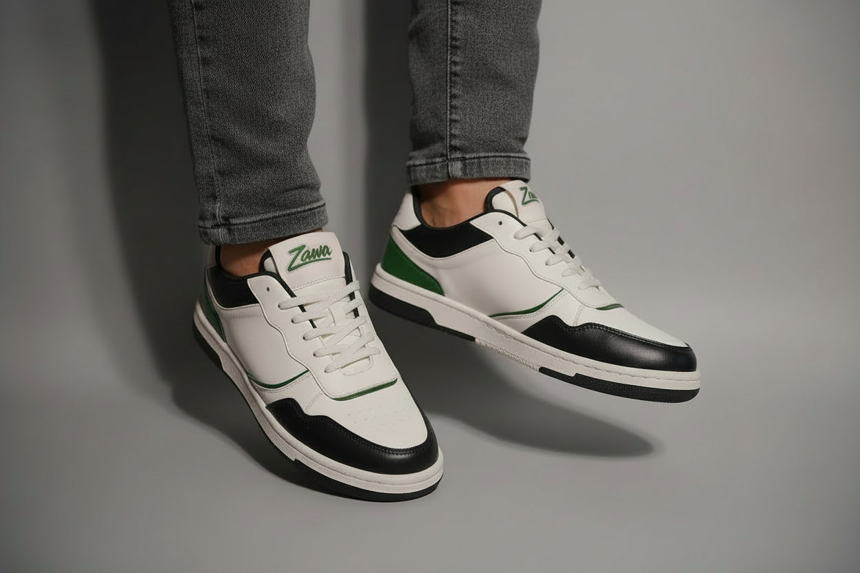 White and black zawa noctyra sneakers with green accents on a gray background