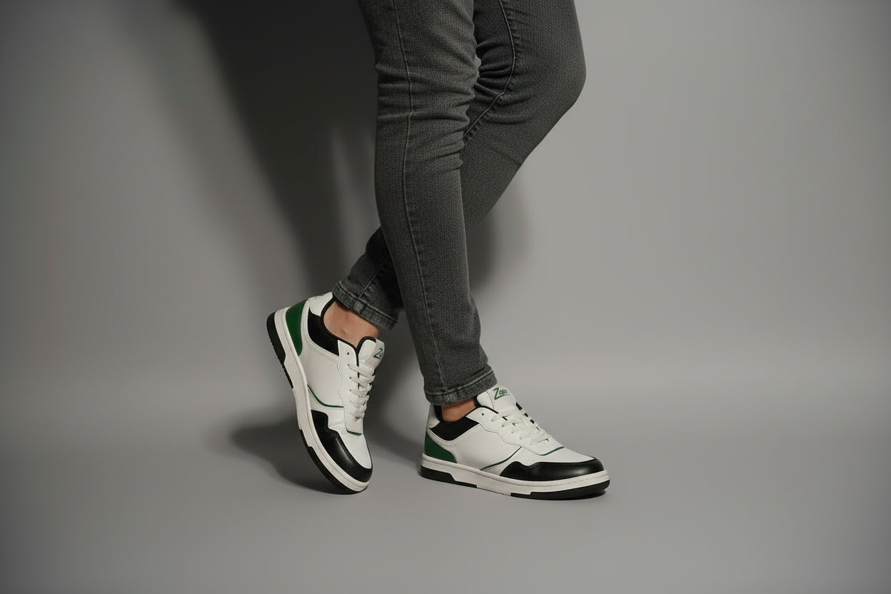 White zawa noctyra sneakers with black and green accents worn by a person on a gray background