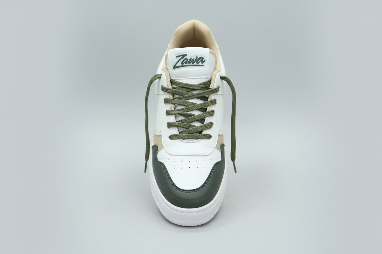 White sneaker with green laces and black accents on a plain background